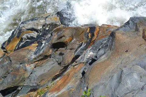 Colorful rocks by flowing water