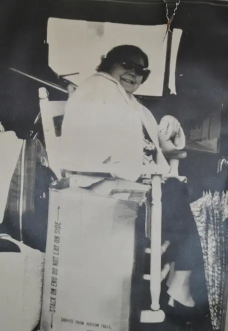 Woman wearing sunglasses in a chair