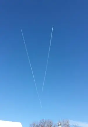 Two contrails crossing in clear sky