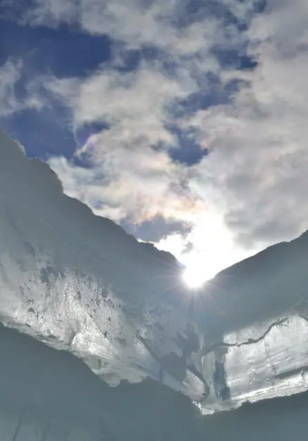 Sunlight peeking through icy mountain crevice
