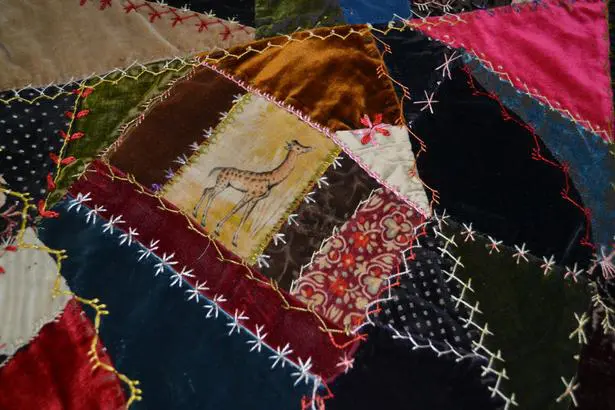 Decorative stitching on vibrant patchwork quilt