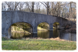 Stone bridge over a calm river