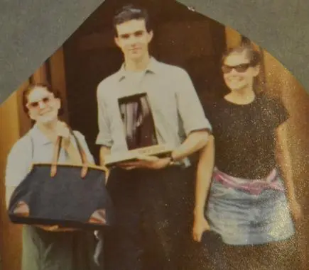 Group holding a trophy and bag